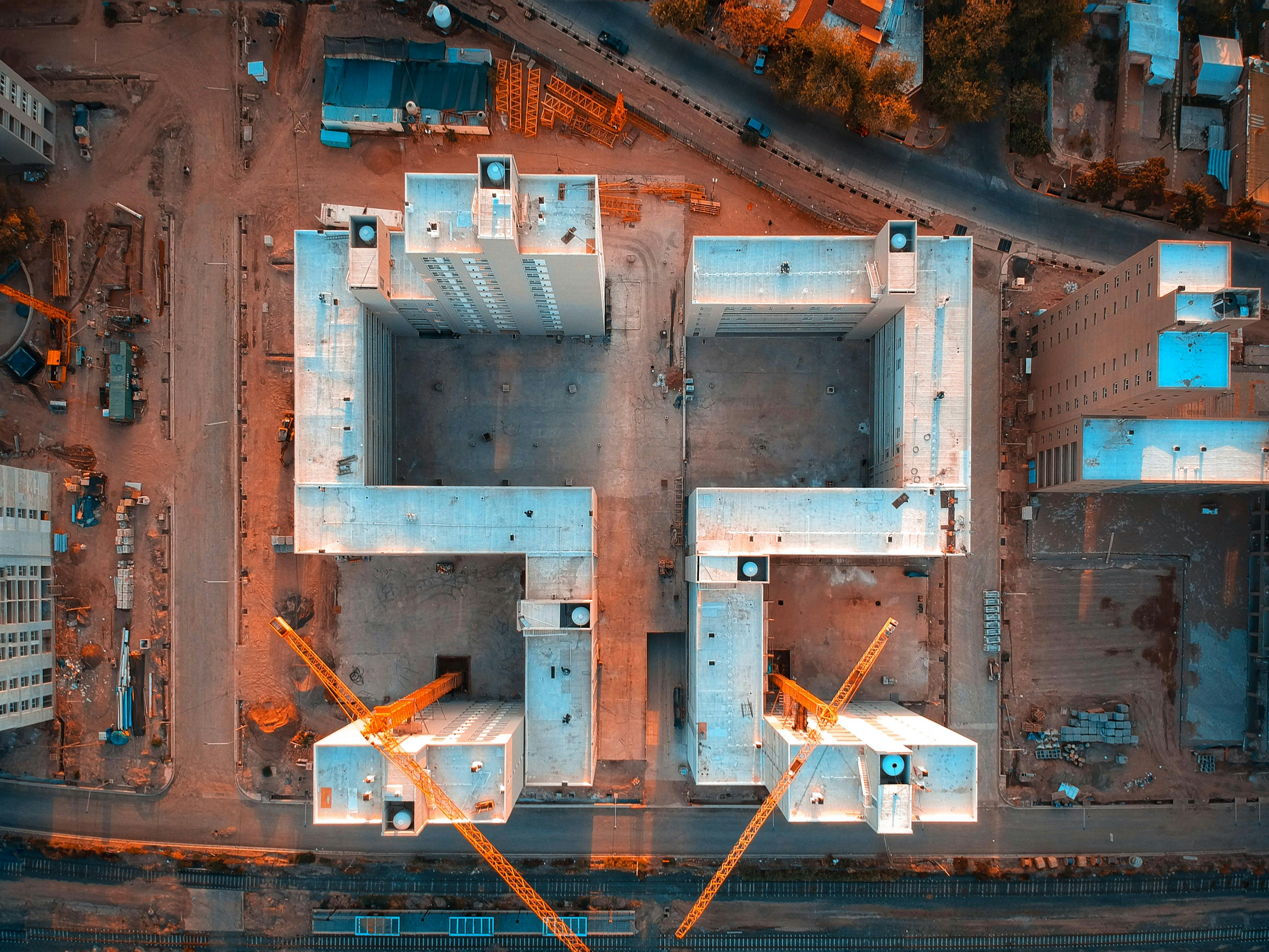 Top-down capital project with cranes and work zones used to represent decision intelligence and operational visibility