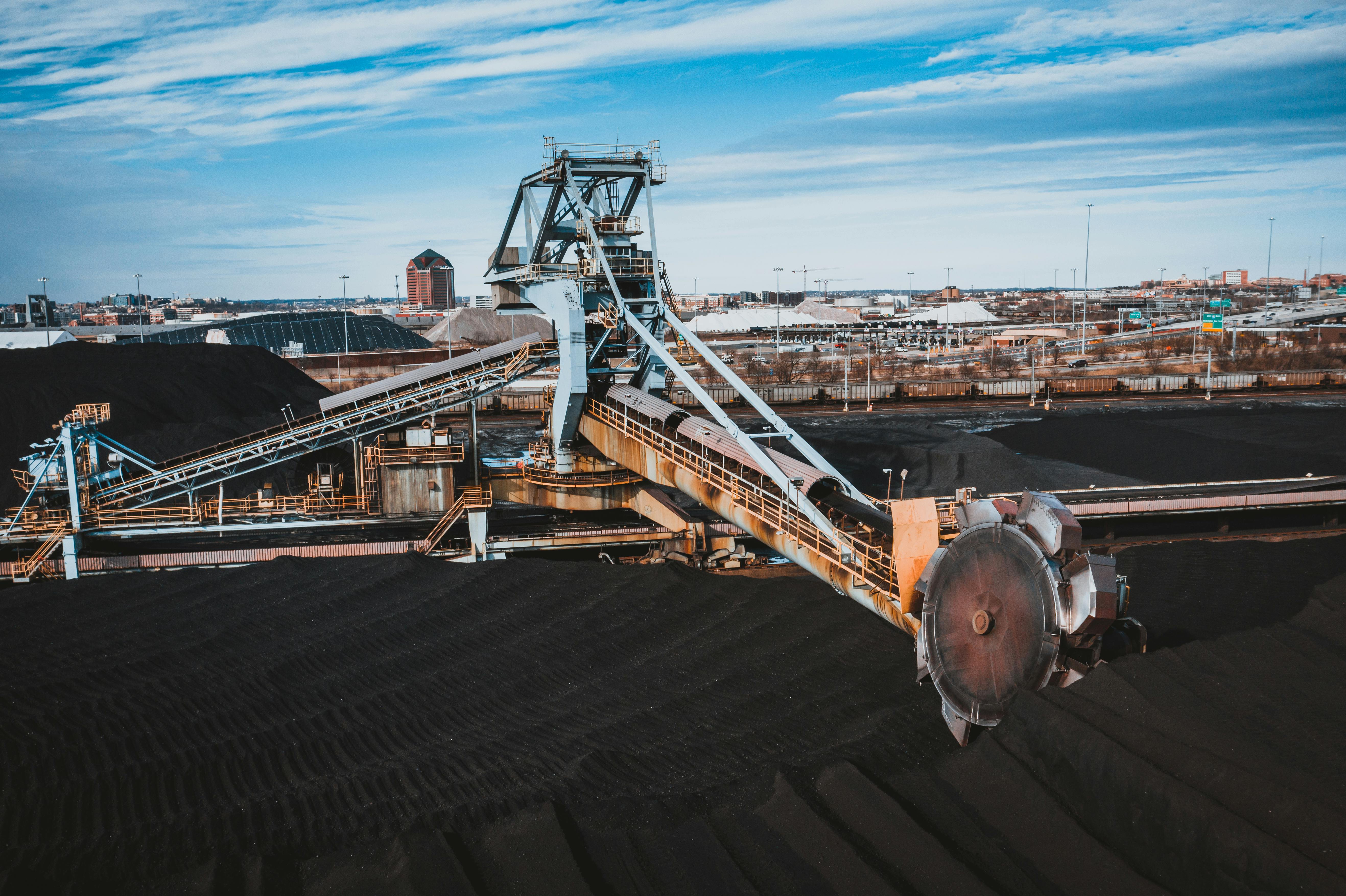 Coal stockyard and conveyor system with reclaiming equipment under a clear sky
