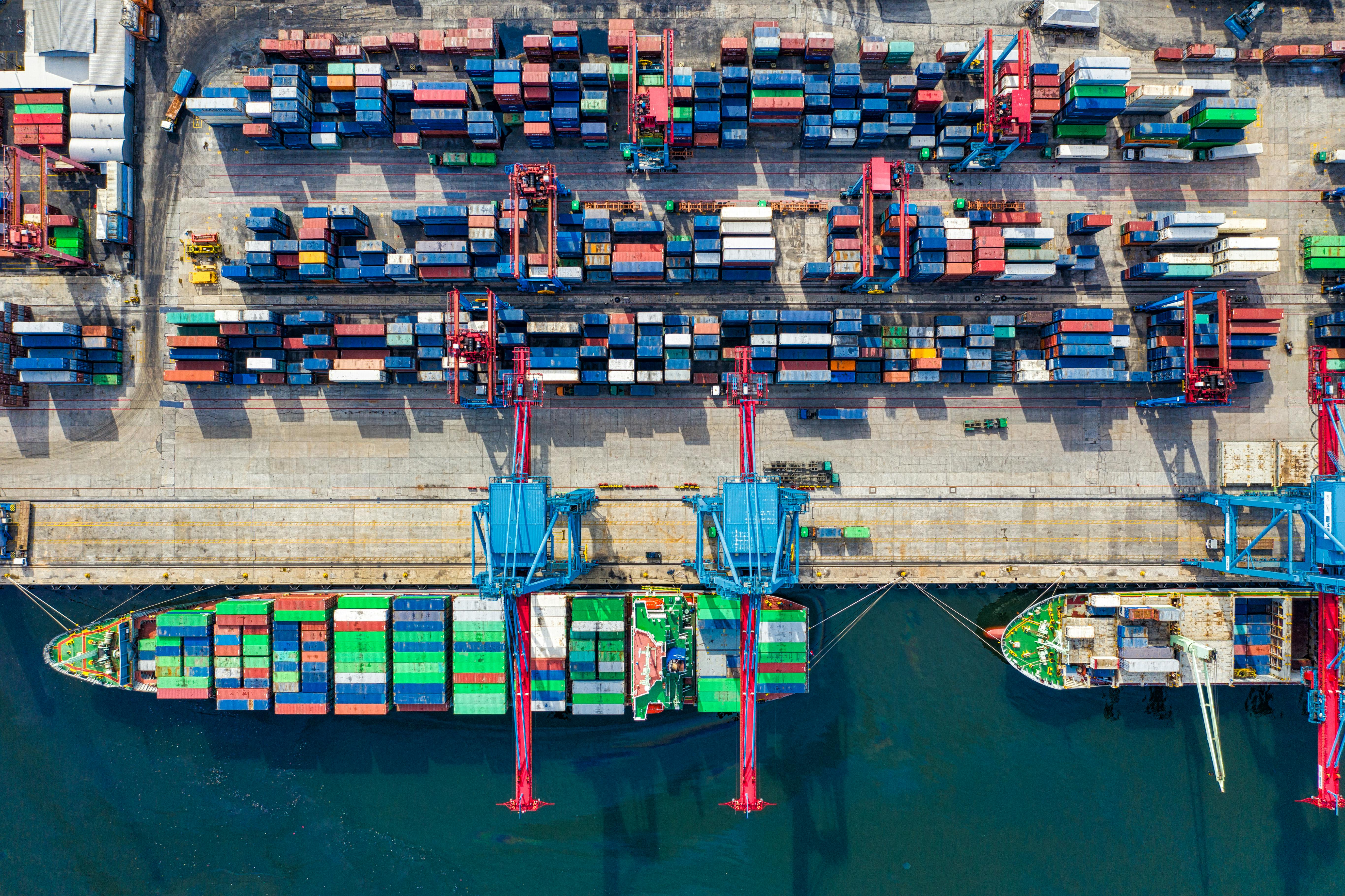 Aerial port logistics operation representing boardroom-scale commodity and asset execution